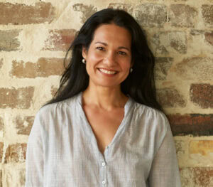Tess Masters standing in front of Brick Wall