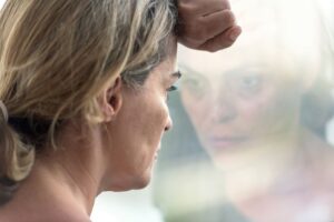 Woman looking out window
