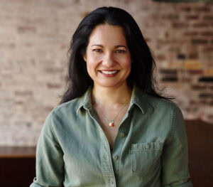 Tess Maters smiling in a green shirt.