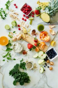 Overhead of an array of fruits on a white marble table
