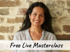 Smiling Tess in front of a brick wall with the text "Free Live Masterclass"
