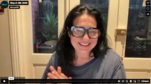Screenshot of a Smiling Tess Filming an Online Webinar
