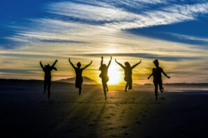 Women jumping for joy on a beach