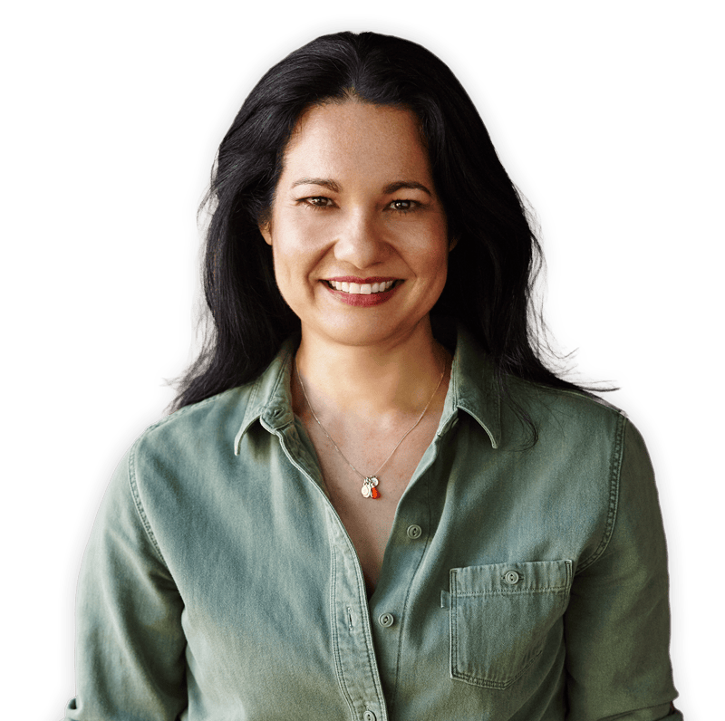 Tess Masters smiling in a casual green button down shirt and jeans