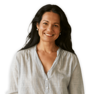 Tess Masters standing and smiling in a breezy button down shirt and jeans