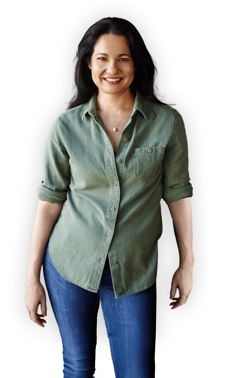 Tess Masters smiling in a casual green button down shirt and jeans
